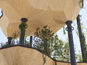 The sculpture is lushly planted with trees and bushes